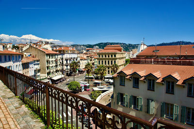 Buildings in city against clear blue sky