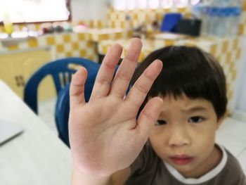 Portrait of boy showing hand