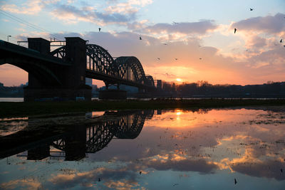 Bridge over river during sunset