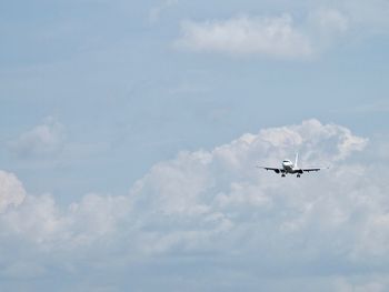 Low angle view of airplane flying in sky