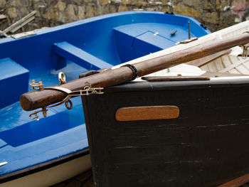 Close-up of old boat against blue sky