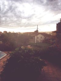 Built structures against cloudy sky