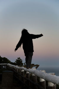 Full length of man standing by sea against clear sky