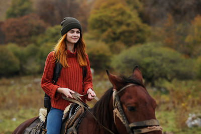 Young woman riding horse