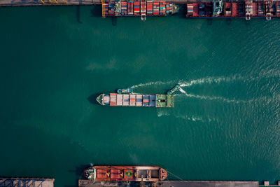 Top view of containers ship floating in sea at shipping port for international import export cargo 