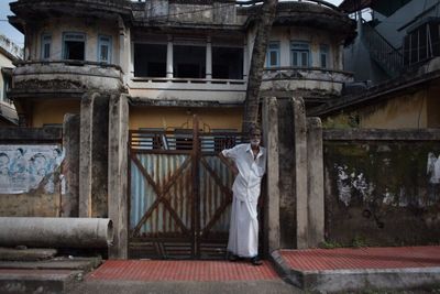 Rear view of man standing outside house
