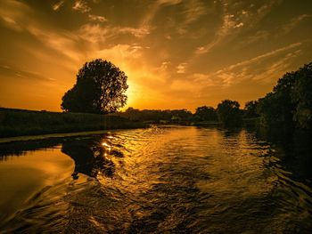 Scenic view of lake against sky during sunset