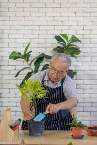 Man holding potted plant