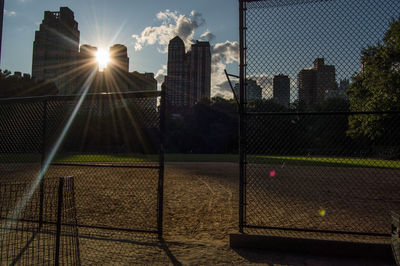 Buildings seen through chainlink fence