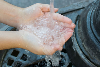 Close-up of woman washing hands