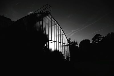 Low angle view of silhouette built structure against sky at sunset