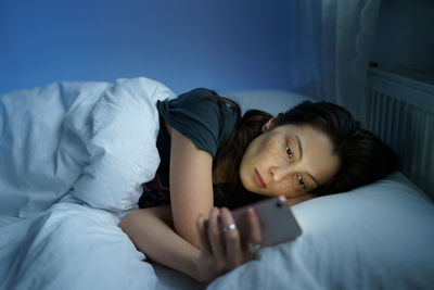 Addicted from social media woman surf internet in dark room at night. sleep disorder problem concept