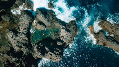 High angle view of rocks in sea