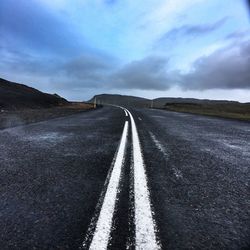 Empty curved road along countryside landscape