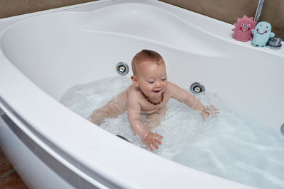 Portrait of boy in bathtub