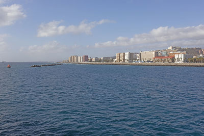 Sea and buildings against sky