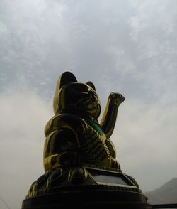 Low angle view of statue against sky