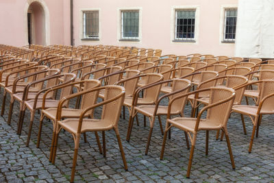 Empty chairs and tables in building