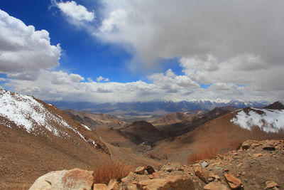 Scenic view of mountains against cloudy sky