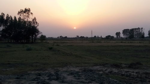 Scenic view of field against sky during sunset