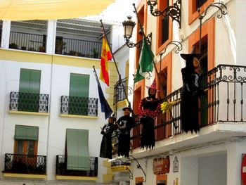 Low angle view of clothes hanging on building in city