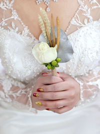 Midsection of woman holding flower bouquet