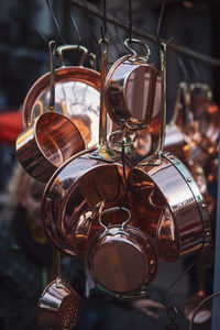 Low angle view of kitchen utensils hanging on hooks at market stall