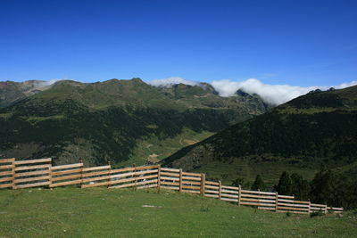 Scenic view of mountains against blue sky