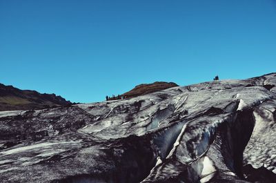 Low angle view of mountain against clear blue sky