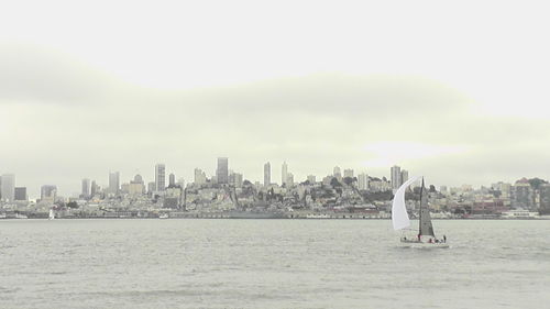 Sailboats sailing on sea against sky