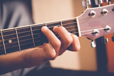 Close-up of hands playing guitar