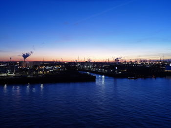 Illuminated city at waterfront