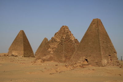 Low angle view of ancient pyramids against sky