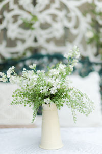 Close-up of white flower vase on table