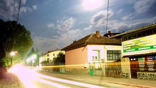 Empty road along buildings