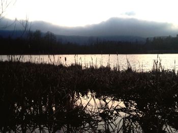 Scenic view of lake against sky during sunset