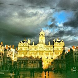 Buildings against cloudy sky