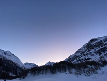 Scenic view of snowcapped mountains against clear blue sky