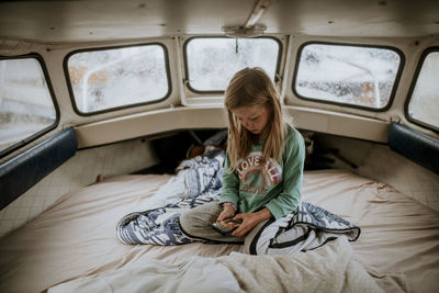 Girl on boat using cell phone