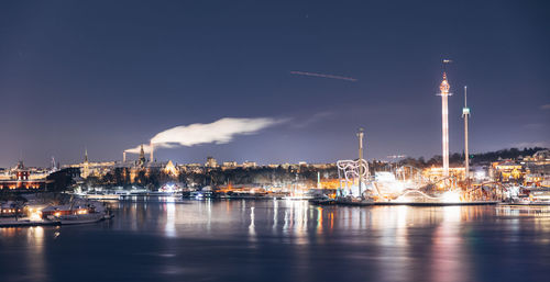 Illuminated city at waterfront