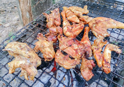 High angle view of meat on barbecue grill