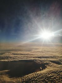 View of calm sea against cloudy sky on sunny day