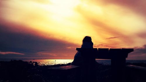 Silhouette of trees against dramatic sky