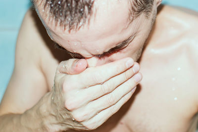 Close-up of man covering face