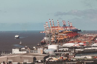 High angle view of commercial dock by sea against sky