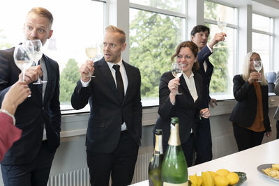 Business people celebrate with champagne
