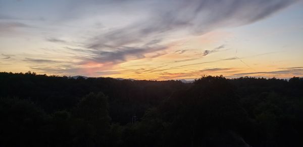 Scenic view of silhouette trees against sky during sunset