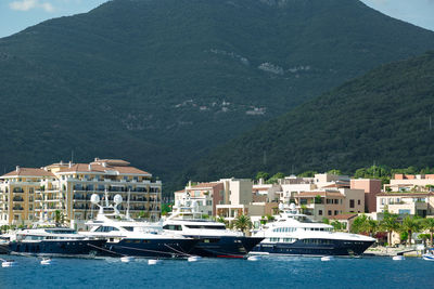 Motor yacht on adriatic sea by buildings against mountains