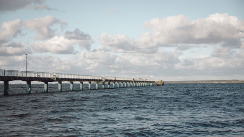 Bridge over sea against sky