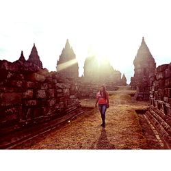 Rear view of woman walking on historical building